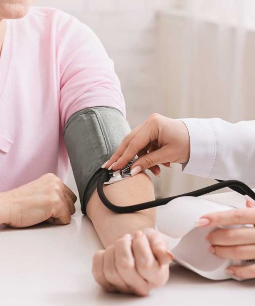 doctor-checking-blood-pressure-of-senior-patient-Y8QNWUE.jpg